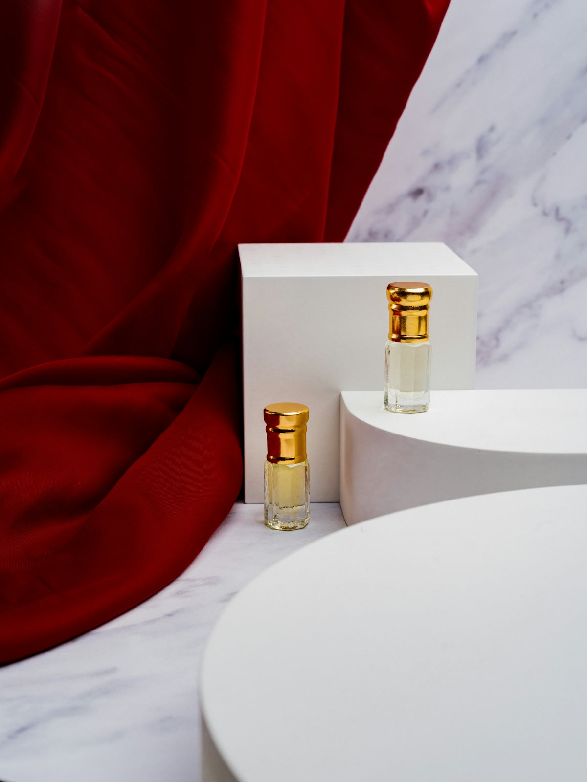 two bottles of perfume sitting on top of a table