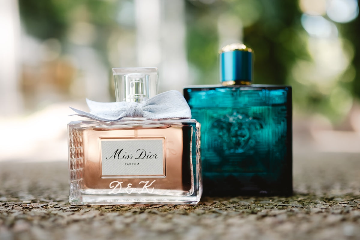 Two perfume bottles are displayed side by side.
